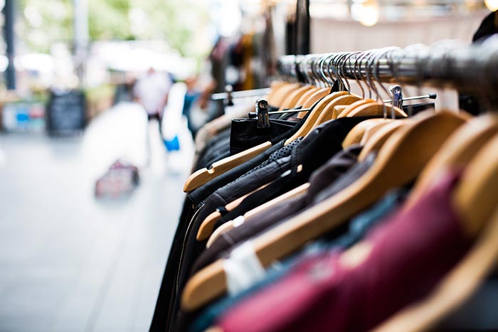 Clothing hanging on a rack on a sidewalk